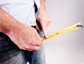 a man measures the length of his penis before enlarging with soda