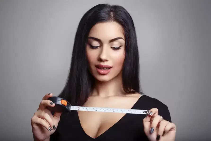 girl with a centimeter and penis measurement after an increase in magnificence