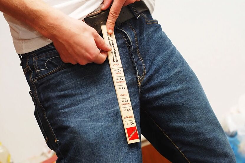 man measuring penis before enlargement